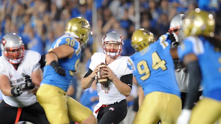 September 10, 2016; Pasadena, CA, USA;  UNLV Rebels quarterback Johnny Stanton (4) looks to pass against the UCLA Bruins during the second half at Rose Bowl. Mandatory Credit: Gary A. Vasquez-Imagn Images
