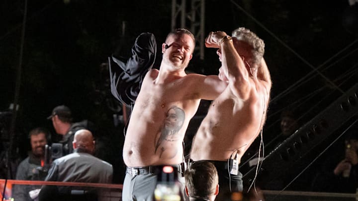 Oregon head coach Dan Lanning, left, and host Pat McAfee strip off their shirts to rally the crowd during ESPN’s “College GameDay” on the campus of the University of Oregon on Oct. 11, 2025, in Eugene, Oregon.