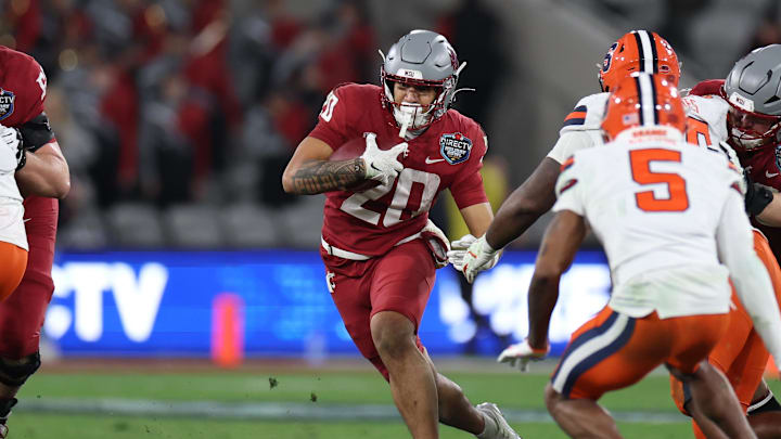 Dec 27, 2024; San Diego, CA, USA; Washington State Cougars running back Leo Pulalasi (20) runs the ball against the Syracuse Orange during the second half at Snapdragon Stadium. Mandatory Credit: Abe Arredondo-Imagn Images