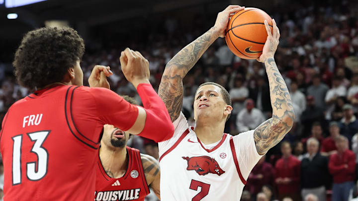 Arkansas Razorbacks forward Trevon Brazile (7) drives to the basket as Louisville Cardinals guard J’Vonne Hadley (1) defends during the first half at Bud Walton Arena.