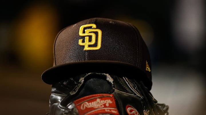 Jun 17, 2022; Denver, Colorado, USA; A detail view of a San Diego Padres hat on a glove in the dugout in the ninth inning against the Colorado Rockies at Coors Field. 