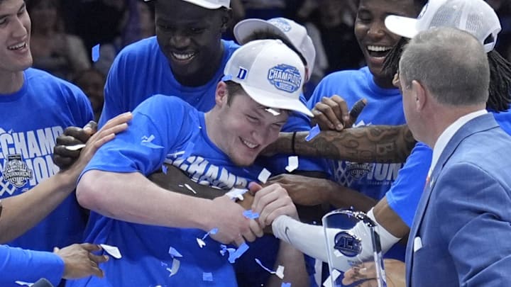 Mar 15, 2025; Charlotte, NC, USA; Duke Blue Devils guard Kon Knueppel (7) celebrates with teammates after winning the 2025 ACC Conference Tournament most valuable player award after the championship game against the Louisville Cardinals at Spectrum Center. Mandatory Credit: Jim Dedmon-Imagn Images