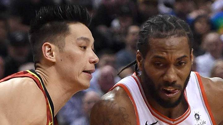 Toronto Raptors forward Kawhi Leonard dribbles the ball around guard Jeremy Lin. Toronto Raptors forward Kawhi Leonard dribbles the ball around guard Jeremy Lin.
