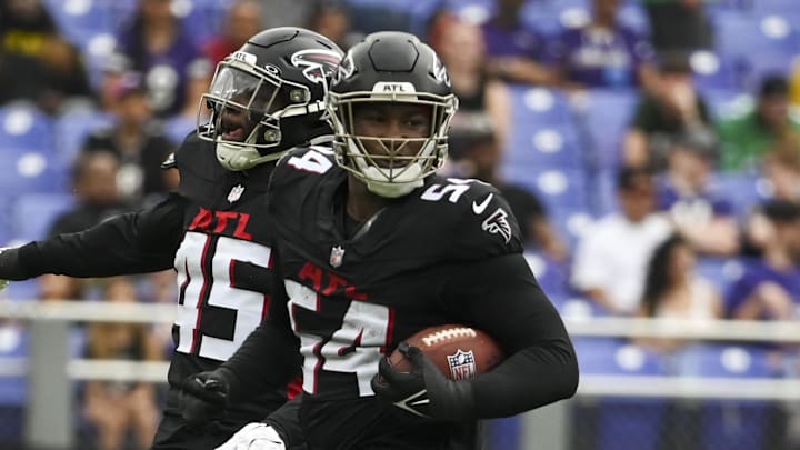 Aug 17, 2024; Baltimore, Maryland, USA;  Atlanta Falcons linebacker Donavan Mutin (45) and defensive tackle Brandon Dorlus (54) celebrate recovering a Baltimore Ravens fumble during the first half at M&T Bank Stadium. Mandatory Credit: Tommy Gilligan-Imagn Images