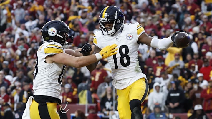 Pittsburgh Steelers wide receiver Mike Williams celebrates with Pat Freiermuth after catching a touchdown pass.