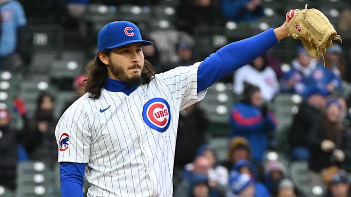 Apr 9, 2025; Chicago, Illinois, USA; Chicago Cubs relief pitcher Eli Morgan (33) reacts to a play during the eigth inning against the Texas Rangers at Wrigley Field.
