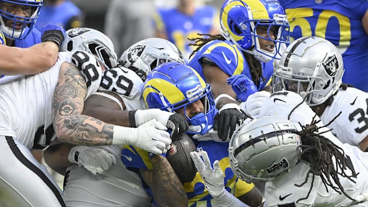 Oct 20, 2024; Inglewood, California, USA; Los Angeles Rams running back Kyren Williams (23) is gang tackled by Las Vegas Raiders defensive end Maxx Crosby (98), Adam Butler (69), Tre'von Moehrig (7) and  Thomas Harper (34) at SoFi Stadium. Mandatory Credit: Robert Hanashiro-Imagn Images