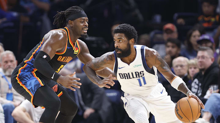 Nov 17, 2024; Oklahoma City, Oklahoma, USA; Dallas Mavericks guard Kyrie Irving (11) moves the ball around Oklahoma City Thunder guard Luguentz Dort (5) during the second half at Paycom Center. Mandatory Credit: Alonzo Adams-Imagn Images