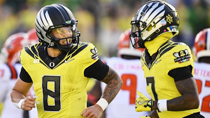 Oct 26, 2024; Eugene, Oregon, USA; Oregon Ducks quarterback Dillon Gabriel (8) celebrates with wide receiver Evan Stewart (7) after scoring a touchdown during the first half against Illinois Fighting Illini at Autzen Stadium. Mandatory Credit: Troy Wayrynen-Imagn Images