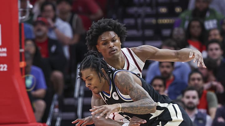 Feb 25, 2025; Houston, Texas, USA; Houston Rockets forward Amen Thompson (1) defends against Milwaukee Bucks guard Kevin Porter Jr. (3) during the first quarter at Toyota Center. Mandatory Credit: Troy Taormina-Imagn Images