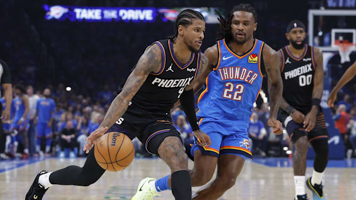 Apr 19, 2026; Oklahoma City, Oklahoma, USA; Phoenix Suns guard Jalen Green (4) drives past Oklahoma City Thunder guard Cason Wallace (22) in the second quarter during game one of the first round of the 2026 NBA Playoffs at Paycom Center. Mandatory Credit: Alonzo Adams-Imagn Images
