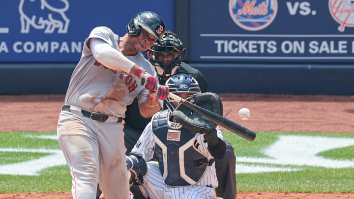 Jul 6, 2024; Bronx, New York, USA; Boston Red Sox third baseman Rafael Devers (11) hits a solo home run during the fifth inning against the New York Yankees at Yankee Stadium.