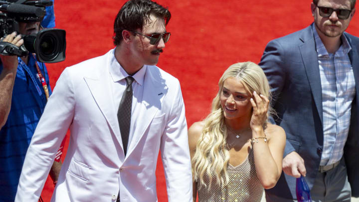 Jul 16, 2024; Arlington, Texas, USA; National League pitcher Paul Skenes of the Pittsburgh Pirates walks the red carpet with his girlfriend LSU gymnast Olivia Livvy Dunne before the 2024 MLB All-Star game at Globe Life Field. 
