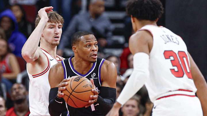 Oct 29, 2025; Chicago, Illinois, USA; Sacramento Kings forward Russell Westbrook (18) looks to pass the ball against Chicago Bulls guard Tre Jones (30) during the first half at United Center. Mandatory Credit: Kamil Krzaczynski-Imagn Images