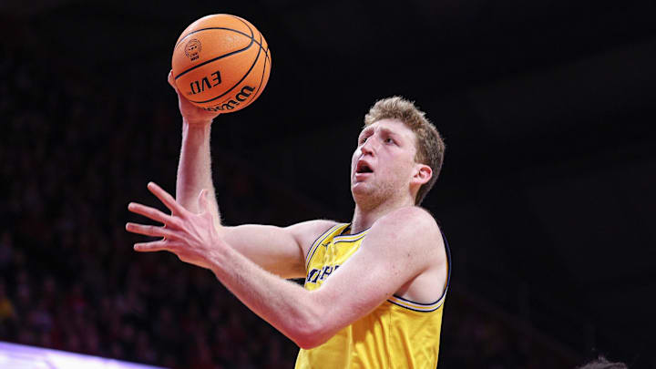 Michigan Wolverines center Danny Wolf (1) drives to the basket against Rutgers Scarlet Knights center Lathan Sommerville (24) during the first half at Jersey Mike's Arena.