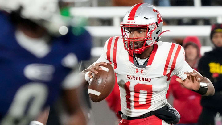 Dec 5, 2025; Birmingham, AL, USA; Saraland's Jamison Roberts (10) escapes a pass rush to throw a touchdown pass at the end of the first half against Clay-Chalkville at Protective Life Stadium in the AHSAA 6A State Championship game.
