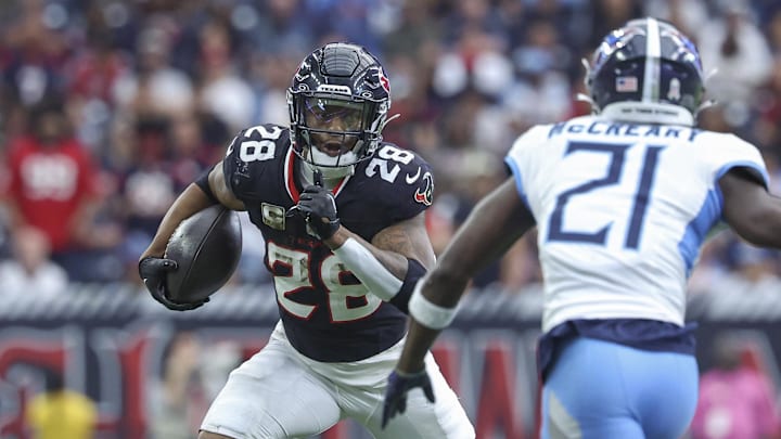 Nov 24, 2024; Houston, Texas, USA; Houston Texans running back Joe Mixon (28) runs with the ball as Tennessee Titans cornerback Roger McCreary (21) defends during the fourth quarter at NRG Stadium. Mandatory Credit: Troy Taormina-Imagn Images Nov 24, 2024; Houston, Texas, USA; Houston Texans running back Joe Mixon (28) runs with the ball as Tennessee Titans cornerback Roger McCreary (21) defends during the fourth quarter at NRG Stadium. Mandatory Credit: Troy Taormina-Imagn Images