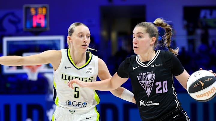 Jun 17, 2025; Arlington, Texas, USA;  Golden State Valkyries guard Kate Martin (20) dribbles as Dallas Wings guard Paige Bueckers (5) defends during the first half at College Park Center. Mandatory Credit: Kevin Jairaj-Imagn Images