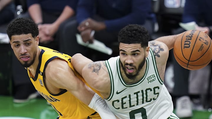 May 21, 2024; Boston, Massachusetts, USA; Boston Celtics forward Jayson Tatum (0) drives the ball against Indiana Pacers guard Tyrese Haliburton (0) in over-time during game one of the eastern conference finals for the 2024 NBA playoffs at TD Garden. Mandatory Credit: David Butler II-Imagn Images