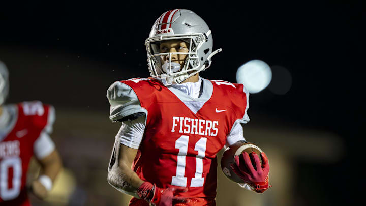 Fishers High School senior JonAnthony Hall (11) runs the ball up field during the first half of an IHSAA varsity football game against Brownsburg High School, Friday, Sept. 20, 2024, at Fishers High School.
