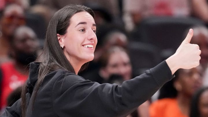 Indiana Fever's Caitlin Clark (22) gives a thumbs up to Los Angeles Sparks's Kelsey Plum (10) after she travels with the ball Saturday, July 19, 2025, during the WNBA All-Star Game at Gainbridge Fieldhouse in Indianapolis.