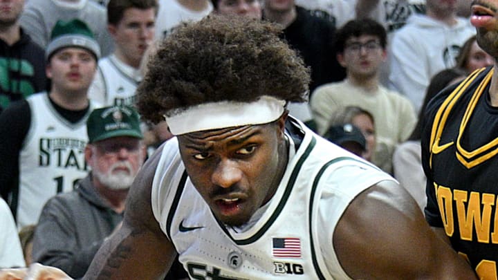 Dec 2, 2025; East Lansing, Michigan, USA;  Michigan State Spartans forward Coen Carr (55) drives past Iowa Hawkeyes guard Kael Combs (11) during the second half at Jack Breslin Student Events Center.