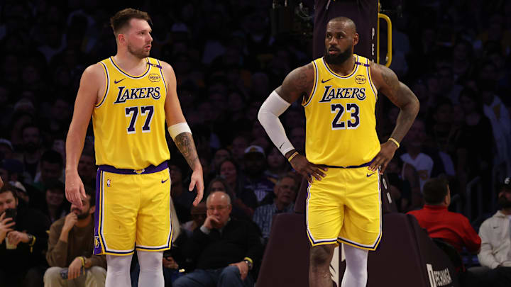 Los Angeles Lakers guard Luka Doncic (77) and forward LeBron James (23) stand on the court during the second quarter against the Minnesota Timberwolves at Crypto.com Arena.