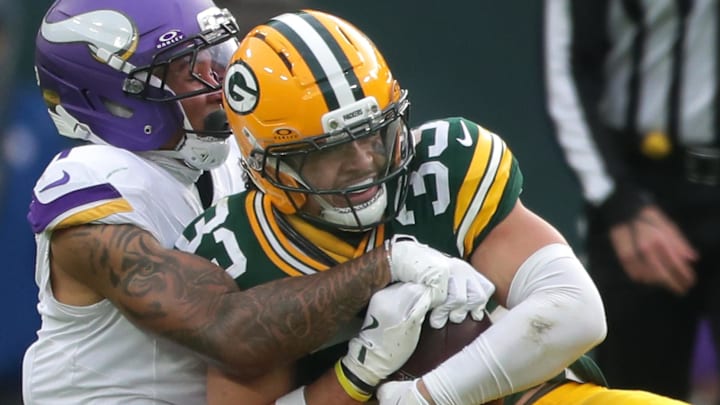 Green Bay Packers safety Evan Williams (33) intercepts a pass intended fo Minnesota Vikings wide receiver Jalen Nailor.