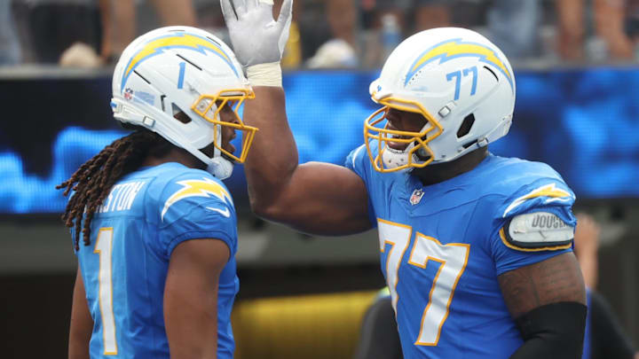 Sep 21, 2025; Inglewood, California, USA; Los Angeles Chargers wide receiver Quentin Johnston (1) and Los Angeles Chargers guard Zion Johnson (77) react after a play during the first half against the Denver Broncos at SoFi Stadium. Mandatory Credit: William Navarro-Imagn Images