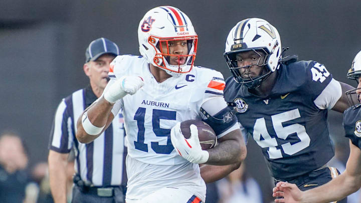 Auburn defensive end Keldric Faulk faces a tough one-on-one battle against Alabama's Kadyn Procter.