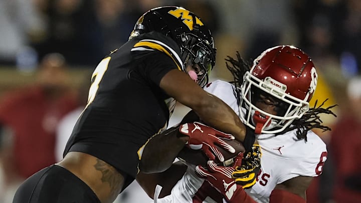 Nov 9, 2024; Columbia, Missouri, USA; Oklahoma Sooners wide receiver Deion Burks (6) is tackled by Missouri Tigers safety Daylan Carnell (13) during the first half at Faurot Field at Memorial Stadium. Mandatory Credit: Jay Biggerstaff-Imagn Images Nov 9, 2024; Columbia, Missouri, USA; Oklahoma Sooners wide receiver Deion Burks (6) is tackled by Missouri Tigers safety Daylan Carnell (13) during the first half at Faurot Field at Memorial Stadium. Mandatory Credit: Jay Biggerstaff-Imagn Images
