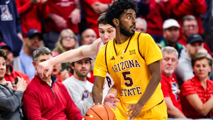 Jan 14, 2026; Tucson, Arizona, USA; Arizona Wildcats forward Ivan Kharchenkov (8) attempts to steal the ball from Arizona State Sun Devils guard Moe Odum (5) during the second half of the game at McKale Memorial Center. Mandatory Credit: Aryanna Frank-Imagn Images