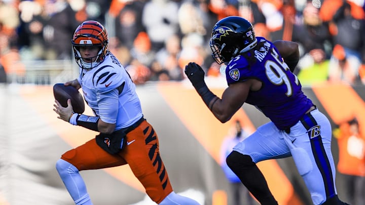 Dec 14, 2025; Cincinnati, Ohio, USA; Cincinnati Bengals quarterback Joe Burrow (9) runs with the ball against Baltimore Ravens linebacker Tavius Robinson (95) in the first half at Paycor Stadium. Mandatory Credit: Katie Stratman-Imagn Images
Dec 14, 2025; Cincinnati, Ohio, USA; Cincinnati Bengals quarterback Joe Burrow (9) runs with the ball against Baltimore Ravens linebacker Tavius Robinson (95) in the first half at Paycor Stadium. Mandatory Credit: Katie Stratman-Imagn Images