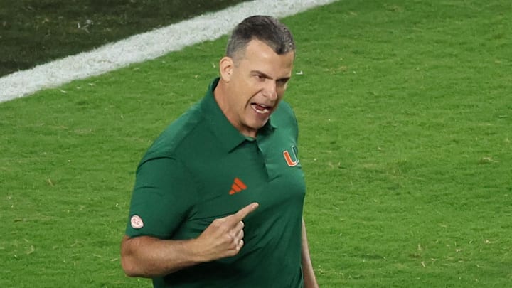 Jan 19, 2026; Miami Gardens, FL, USA; Miami Hurricanes head coach Mario Cristobal speaks to his players during warmups prior to the College Football Playoff National Championship game against the Indiana Hoosiers at Hard Rock Stadium. Mandatory Credit: Kim Klement Neitzel-Imagn Images