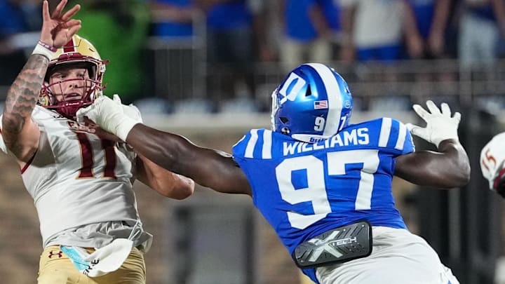 Aug 28, 2025; Durham, North Carolina, USA; Elon Phoenix quarterback Landen Clark (11) is hit by Duke Blue Devils defensive end Wesley Williams (97) on his pass during the second half at Wallace Wade Stadium. 