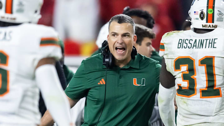 Jan 19, 2026; Miami Gardens, FL, USA; Miami Hurricanes head coach Mario Cristobal with linebacker Wesley Bissainthe (31) against the Indiana Hoosiers during the College Football Playoff National Championship game at Hard Rock Stadium. Mandatory Credit: Mark J. Rebilas-Imagn Images