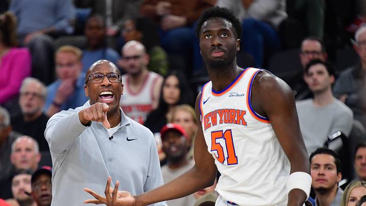 New York Knicks head coach Mike Brown watches game action as forward Mohamed Diawara looks around. 
