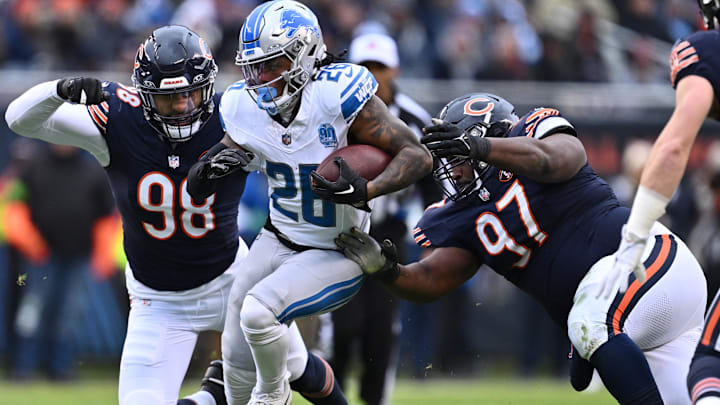 Andrew Billings (97) and Montez Sweat reach out to try and bring down Detroit's Jahmyr Gibbs. Andrew Billings (97) and Montez Sweat reach out to try and bring down Detroit's Jahmyr Gibbs.