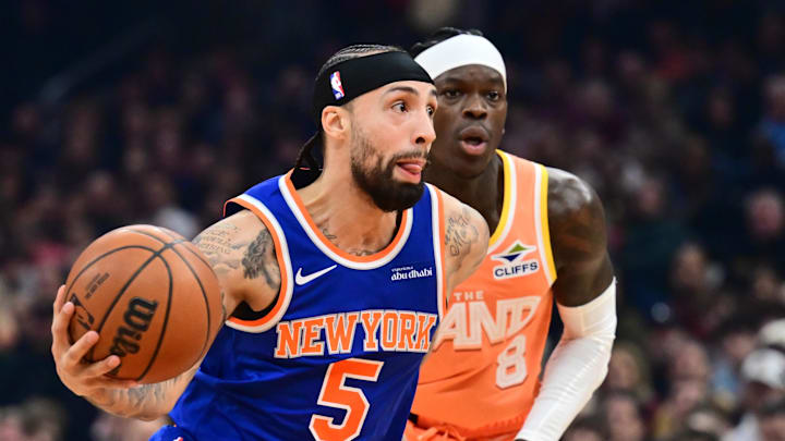 Feb 24, 2026; Cleveland, Ohio, USA; New York Knicks guard Jose Alvarado (5) drives to the basket against Cleveland Cavaliers guard Dennis Schroder (8) during the first half at Rocket Arena. Mandatory Credit: Ken Blaze-Imagn Images