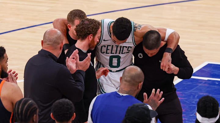 May 12, 2025; New York, New York, USA; Boston Celtics forward Jayson Tatum (0) is helped off the court by after an injury in the second half during game four of the second round for the 2025 NBA Playoffs against the New York Knicks at Madison Square Garden. Tatum would leave the game with an injury after this play. Mandatory Credit: Vincent Carchietta-Imagn Images May 12, 2025; New York, New York, USA; Boston Celtics forward Jayson Tatum (0) is helped off the court by after an injury in the second half during game four of the second round for the 2025 NBA Playoffs against the New York Knicks at Madison Square Garden. Tatum would leave the game with an injury after this play. Mandatory Credit: Vincent Carchietta-Imagn Images