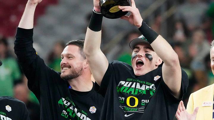 Oregon Ducks quarterback Bo Nix and head coach Dan Lanning celebrate after defeating the Liberty Flames to win the Fiesta Bowl at State Farm Stadium in Glendale on Jan. 1, 2024. Oregon Ducks quarterback Bo Nix and head coach Dan Lanning celebrate after defeating the Liberty Flames to win the Fiesta Bowl at State Farm Stadium in Glendale on Jan. 1, 2024.