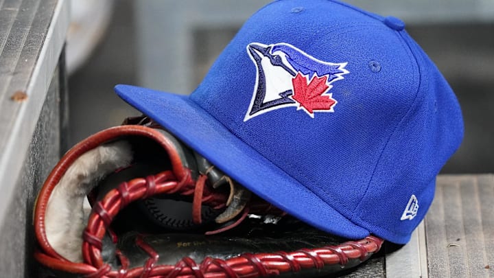 Apr 16, 2025; Toronto, Ontario, CAN; A Toronto Blue Jays hat and glove in the dugout during a game against the Atlanta Braves at Rogers Centre. 