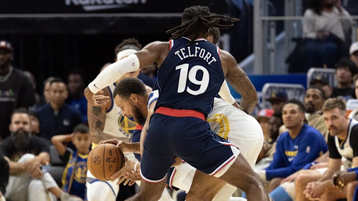 Oct 17, 2025; San Francisco, California, USA; Los Angeles Clippers forward Jahmyl Telfort (19) and forward Patrick Baldwin Jr. (23) double-team Golden State Warriors guard Stephen Curry (30) during the fourth quarter at Chase Center. Mandatory Credit: D. Ross Cameron-Imagn Images