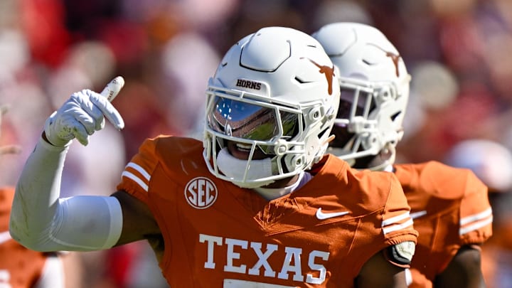 Oct 11, 2025; Dallas, Texas, USA; Texas Longhorns defensive back Malik Muhammad (5) celebrates after an interception during the game between the Texas Longhorns and the Oklahoma Sooners at the Cotton Bowl. 