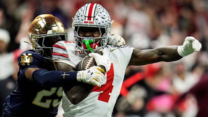 Ohio State Buckeyes wide receiver Jeremiah Smith (4) makes a catch against Notre Dame Fighting Irish cornerback Christian Gray (29) in the fourth quarter during the College Football Playoff National Championship at Mercedes-Benz Stadium in Atlanta on January 20, 2025.