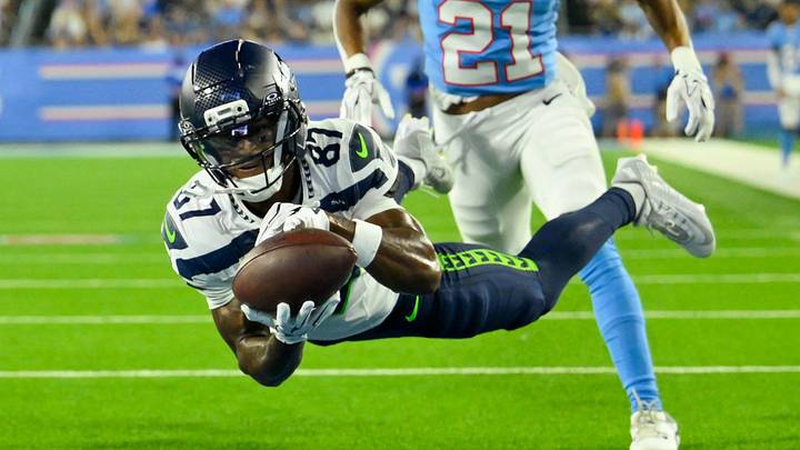 Aug 23, 2026; Nashville, Tennessee, USA; Seattle Seahawks wide receiver Montorie Foster Jr. (87) dives for the ball as Tennessee Titans running back D'Ernest Johnson (21) defends during the first half at Nissan Stadium. Aug 23, 2026; Nashville, Tennessee, USA; Seattle Seahawks wide receiver Montorie Foster Jr. (87) dives for the ball as Tennessee Titans running back D'Ernest Johnson (21) defends during the first half at Nissan Stadium.