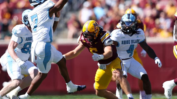 Sep 7, 2024; Minneapolis, Minnesota, USA; Rhode Island Rams quarterback Devin Farrell (7) throws the ball as Minnesota Golden Gophers linebacker Maverick Baranowski (6) defends during the first half at Huntington Bank Stadium. Mandatory Credit: Matt Krohn-Imagn Images