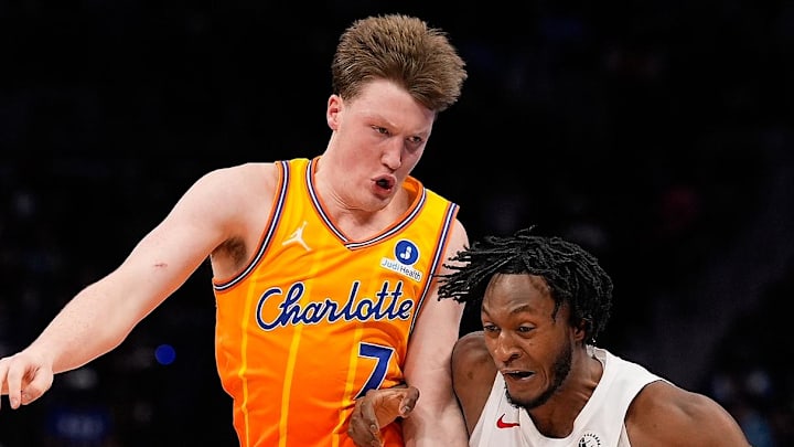 Toronto Raptors guard Immanuel Quickley drives with the ball against Charlotte Hornets guard Kon Knueppel.
