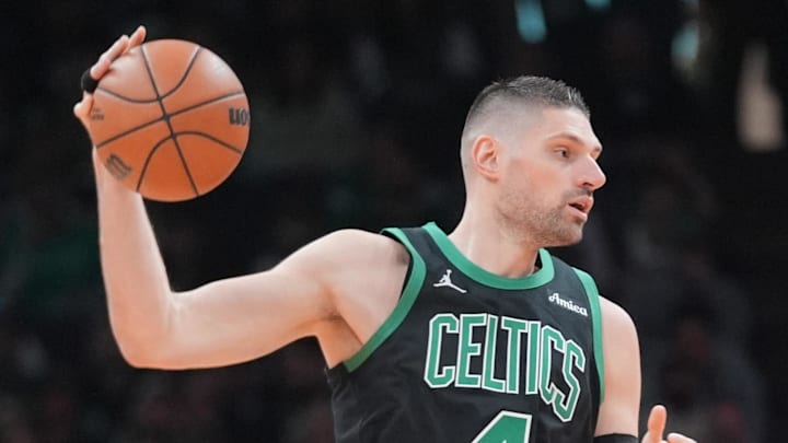 Apr 5, 2026; Boston, Massachusetts, USA; Boston Celtics center Nikola Vucevic (4) receives a pass against Toronto Raptors forward Collin Murray-Boyles (12) during the second half at TD Garden. Mandatory Credit: Gregory Fisher-Imagn Images
