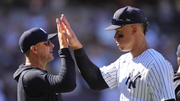 May 28, 2023; Bronx, New York, USA; New York Yankees manager Aaron Boone (17) and right fielder Aaron Judge (99) celebrate the victory against the San Diego Padres after the game at Yankee Stadium. Mandatory Credit: Gregory Fisher-Imagn Images